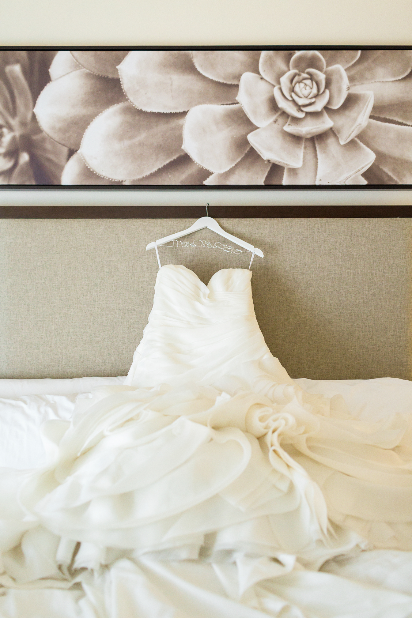 Wedding dress hanging on a headboard