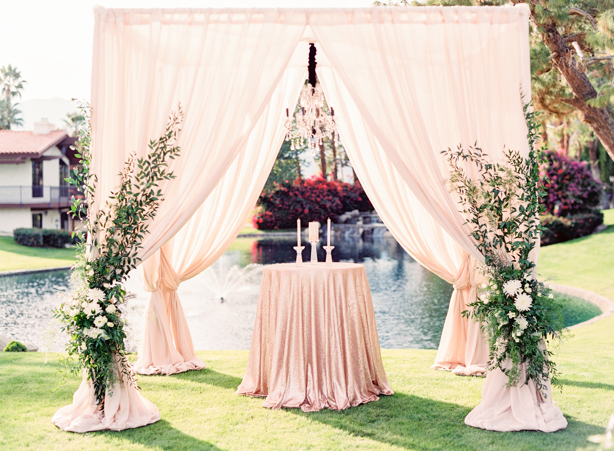 Blush wedding alter with lake in the background